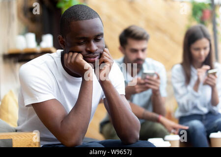 Lonely black male outcast feel sad lack communication Stock Photo