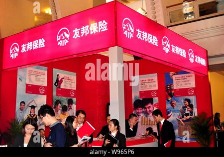 --FILE--People visit the stand of AIA during an expo in Shanghai, China, 19 November 2011.   Insurance giant American International Group Inc said tha Stock Photo