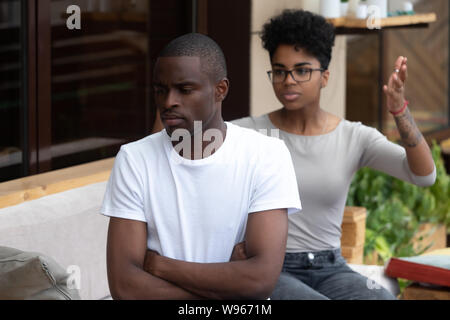 Black couple conflict in caf having relationships problems Stock Photo