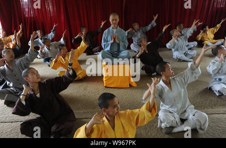 Chinese Buddist monks and nuns of Guangxuan Art Troupe perform a Zen dance during a training session at Tiantai Temple on Tiantai Mountain in HongAn c Stock Photo