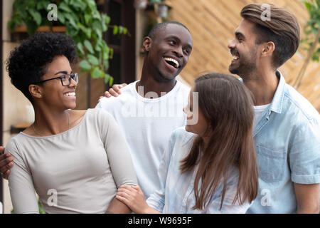 Portrait of smiling multiracial friends posing for picture Stock Photo
