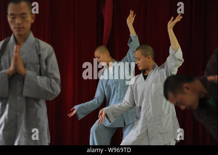 Chinese Buddist monks and nuns of Guangxuan Art Troupe perform a Zen dance during a training session at Tiantai Temple on Tiantai Mountain in HongAn c Stock Photo