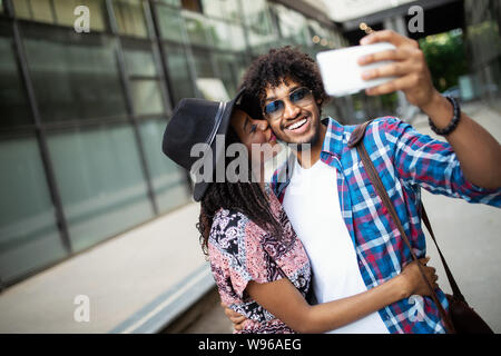 Happy young beautiful loving couple posing walking outdoors in park nature  take selfie by mobile phone kissing. Stock Photo by ©Vadymvdrobot 285890498
