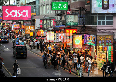 Pedestrian walk on a busy street in Hong Kong, China, 28 June 2012.   Chinas State Council, or the Cabinet, announced in late June measures aimed at b Stock Photo