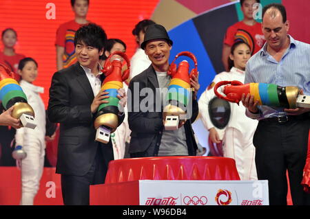 Chinese pianist Lang Lang, left, and Hong Kong singer Jacky Cheung, center, pose during a ceremony by Coca-Cola to release an Olympic theme song at th Stock Photo