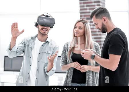 Positive colleagues testing virtual reality device Stock Photo