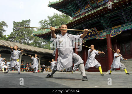 --FILE--Chinese monks perform at the Shaolin Temple in Dengfeng city, central Chinas Henan province, 24 July 2011.   The Shaolin Temple scenic spot is Stock Photo