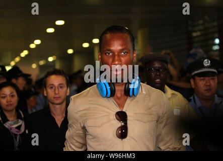 Former Chelsea midfielder Didier Drogba, left, holds his Shanghai