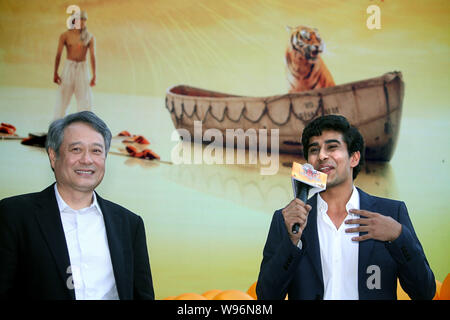 Taiwanese director Ang Lee, left, Indian actor Suraj Sharma are interviewed during a press conference for the 3D movie, Life of Pi, in Taipei, Taiwan, Stock Photo