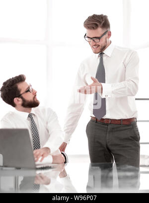 two employees discuss business issues near the office Desk Stock Photo