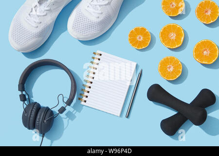 Sport flat lay with gym equipment and accessories on blue fitness background Stock Photo