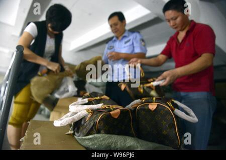 FILE--A handbag and wallets are showcased at a fashion store of Louis  Vuitton (LV) in Fuzhou city, southeast China's Fujian province, 18 January  201 Stock Photo - Alamy