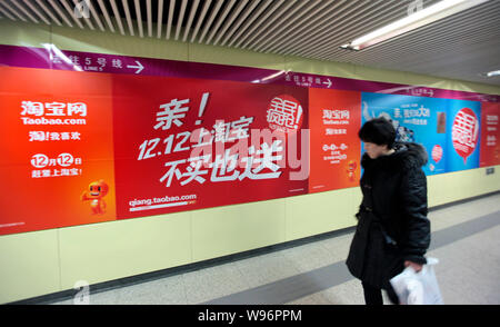 --File--A pedestrian walks past an advertisement for Taobao.com in Beijing, China, 6 December 2011.   A number of employees at Taobao, Chinas largest Stock Photo