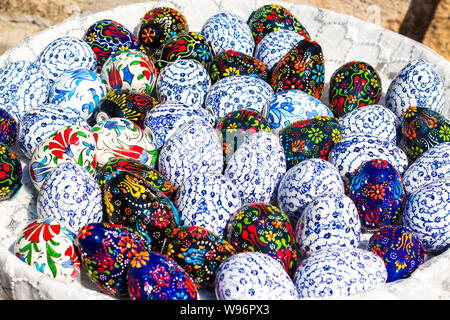 Many eggs in various patterns of a blue shade. Eggs are painted by Easter and stacked in a large plate. The patterns are very beautiful Stock Photo