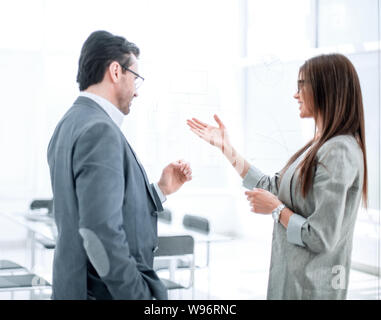 businessman and businesswoman discussing something in the new office Stock Photo