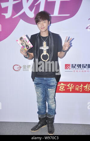 Taiwanese singer Show Lo poses with his new album during the album signing meeting in Beijing, China, 11 June 2012. Stock Photo
