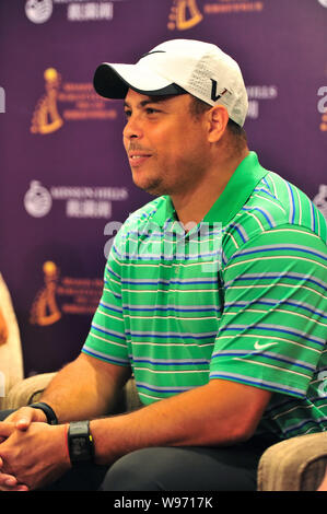 Former Brazilian soccer superstar Ronaldo poses with the champion