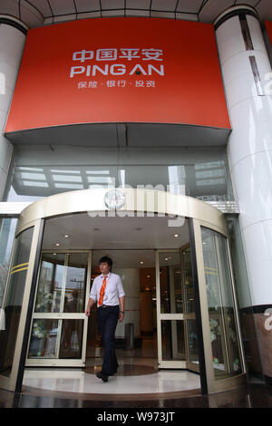 --FILE--A Chinese staff member walks out from a branch of Ping An of China in Shanghai, China, 5 September 2012.   Ping An, Chinas second-biggest insu Stock Photo