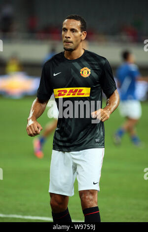 Rio Ferdinand of Manchester United warms up with teammates before their friendly soccer match against Shanghai Shenhua during the pre-season tour of M Stock Photo