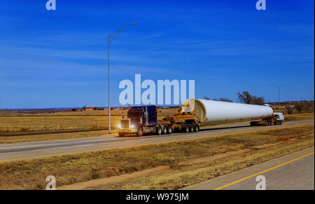 Transporting wing the farm wind turbines blade on trailer Stock Photo