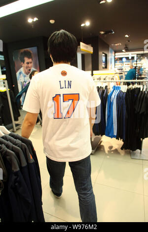 A customer wearing a T-shirt of New York Knicks Jeremy Lin poses
