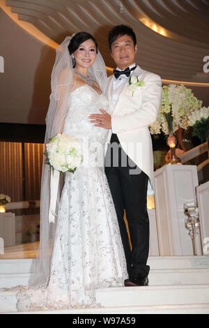 Hong Kong actor Chin Ka Lok, right, strokes the belly of his pregnant actress wife Angela Tong during their wedding ceremony in Hong Kong, China, Thur Stock Photo
