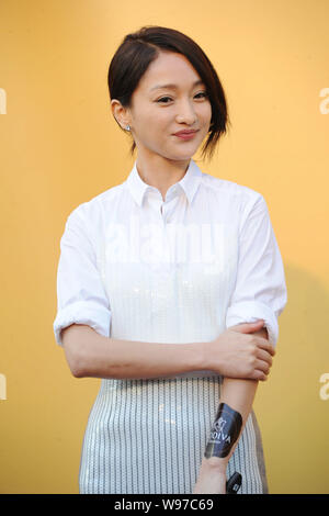 Chinese actress Zhou Xun smiles at the opening ceremony for the chocolate store of Godiva in Beijing, China, 29 November 2012. Stock Photo