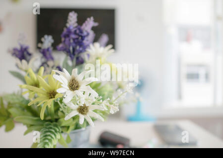 Close up white flowers and purple lavender with pollen. Blooming of fake flower and green leaf. Place the car key and mobile phone on the table and TV Stock Photo