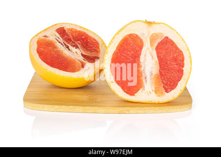Group of two halves of fresh pink grapefruit on bamboo cutting board isolated on white background Stock Photo