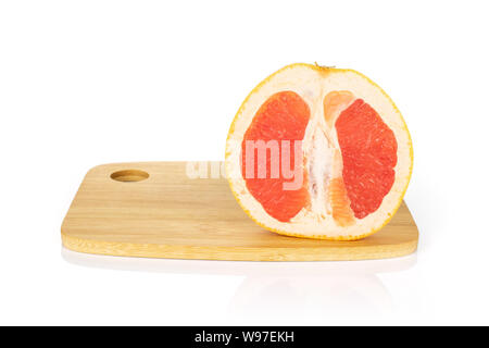 One half of fresh pink grapefruit on bamboo cutting board isolated on white background Stock Photo