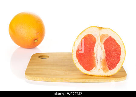 Group of one whole one half of fresh pink grapefruit on bamboo cutting board isolated on white background Stock Photo