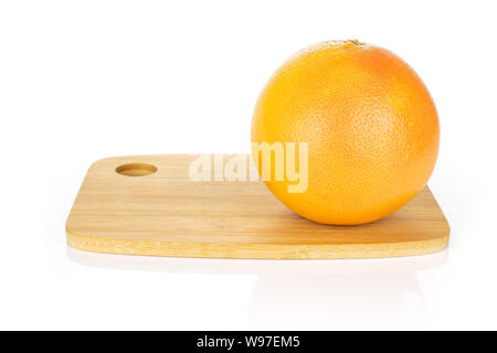 One whole fresh pink grapefruit on bamboo cutting board isolated on white background Stock Photo