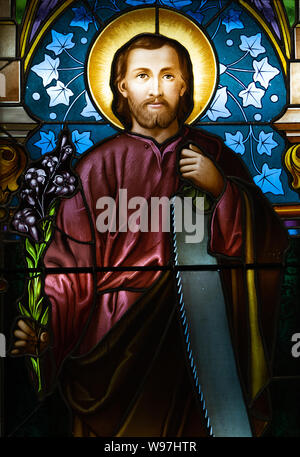 A stained-glass window depicting Saint Joseph. Displayed at the Bishop's office. Stock Photo