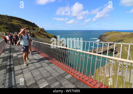 People on the controversial new footbridge re-connecting both halves of Tintagel Castle for the first time in 500 years, has at long last been opened. The medieval castle on the Cornwall coast - long rumoured to be the site of King Arthur's legendary Camelot - lost its original bridge sometime between the 15th and 16th centuries. A storm which hit the Cornish coast delayed the bridge's opening. Stock Photo