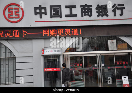 --File--A pedestrian walks past a branch of Industrial and Commercial Bank of China (ICBC) in Qingdao, east Chinas Shandong province, 13 October 2011. Stock Photo