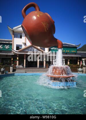 Guizhou, Guizhou, China. 13th Aug, 2019. Guizhou, CHINA-A giant teapot is seen pouring water over the tianfu expressway service area in Guiding county, Qiannan autonomous prefecture, Guizhou province, Aug. 11, 2019.The giant teapot was about two metres above the water, and the water poured down in a column that looked as if it were hanging in the air.Instead, the suspended teapot is supported by plastic pipes in a water column, which pump water out of the pipes and then release the water to form a circulation. Credit: SIPA Asia/ZUMA Wire/Alamy Live News Stock Photo