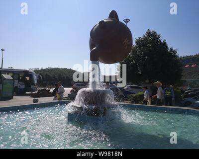 Guizhou, Guizhou, China. 13th Aug, 2019. Guizhou, CHINA-A giant teapot is seen pouring water over the tianfu expressway service area in Guiding county, Qiannan autonomous prefecture, Guizhou province, Aug. 11, 2019.The giant teapot was about two metres above the water, and the water poured down in a column that looked as if it were hanging in the air.Instead, the suspended teapot is supported by plastic pipes in a water column, which pump water out of the pipes and then release the water to form a circulation. Credit: SIPA Asia/ZUMA Wire/Alamy Live News Stock Photo