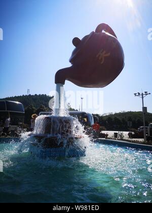 Guizhou, Guizhou, China. 13th Aug, 2019. Guizhou, CHINA-A giant teapot is seen pouring water over the tianfu expressway service area in Guiding county, Qiannan autonomous prefecture, Guizhou province, Aug. 11, 2019.The giant teapot was about two metres above the water, and the water poured down in a column that looked as if it were hanging in the air.Instead, the suspended teapot is supported by plastic pipes in a water column, which pump water out of the pipes and then release the water to form a circulation. Credit: SIPA Asia/ZUMA Wire/Alamy Live News Stock Photo