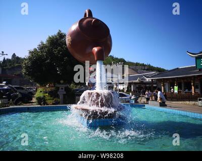 Guizhou, Guizhou, China. 13th Aug, 2019. Guizhou, CHINA-A giant teapot is seen pouring water over the tianfu expressway service area in Guiding county, Qiannan autonomous prefecture, Guizhou province, Aug. 11, 2019.The giant teapot was about two metres above the water, and the water poured down in a column that looked as if it were hanging in the air.Instead, the suspended teapot is supported by plastic pipes in a water column, which pump water out of the pipes and then release the water to form a circulation. Credit: SIPA Asia/ZUMA Wire/Alamy Live News Stock Photo