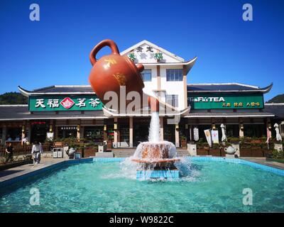 Guizhou, Guizhou, China. 13th Aug, 2019. Guizhou, CHINA-A giant teapot is seen pouring water over the tianfu expressway service area in Guiding county, Qiannan autonomous prefecture, Guizhou province, Aug. 11, 2019.The giant teapot was about two metres above the water, and the water poured down in a column that looked as if it were hanging in the air.Instead, the suspended teapot is supported by plastic pipes in a water column, which pump water out of the pipes and then release the water to form a circulation. Credit: SIPA Asia/ZUMA Wire/Alamy Live News Stock Photo