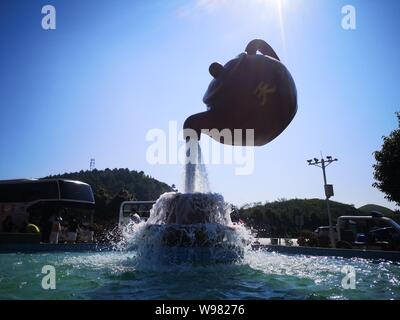 Guizhou, Guizhou, China. 13th Aug, 2019. Guizhou, CHINA-A giant teapot is seen pouring water over the tianfu expressway service area in Guiding county, Qiannan autonomous prefecture, Guizhou province, Aug. 11, 2019.The giant teapot was about two metres above the water, and the water poured down in a column that looked as if it were hanging in the air.Instead, the suspended teapot is supported by plastic pipes in a water column, which pump water out of the pipes and then release the water to form a circulation. Credit: SIPA Asia/ZUMA Wire/Alamy Live News Stock Photo