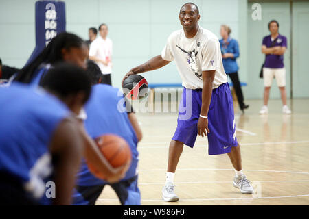 NBA star Kobe Bryant coaches young basketball players at a meeting with ...