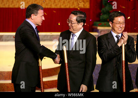 Robert A. Iger (Bob Iger), left, President and CEO of The Walt Disney Company, shakes hands with Yu Zhengsheng, Secretary of the Shanghai Municipal Co Stock Photo