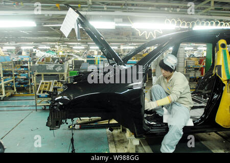 Chinese factory workers assemble Toyota cars on the assembly line at an ...