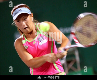 Noppawan Lertcheewakarn of Thailand returns a shot against Zheng Jie of China in their second round during the WTA Guangzhou International Womens Open Stock Photo