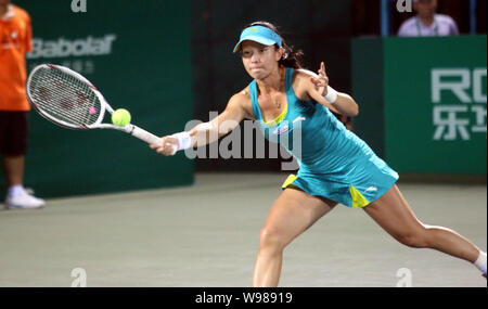 Zheng Jie of China returns a shot against Noppawan Lertcheewakarn of Thailand in their second round during the WTA Guangzhou International Womens Open Stock Photo