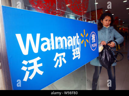 --FILE--A Chinese shopper walks out from a Walmart supermarket in Shanghai, China, 27 January 2011.   Wal-Mart Stores Inc., the worlds biggest retaile Stock Photo