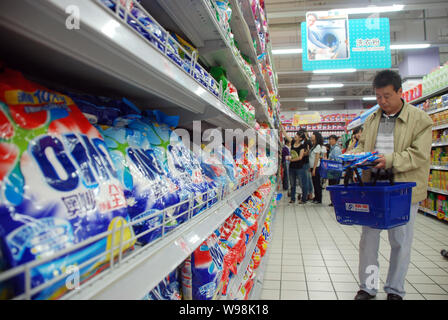 --FILE--A Chinese shopper buys OMO washing powder of Unilever at a supermarket in Hangzhou, east Chinas Zhejiang province, 27 May 2011.  Unilever, the Stock Photo