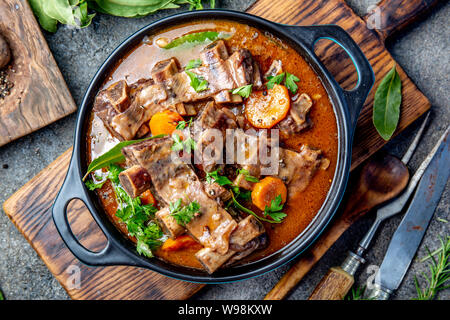 Bourguignon beef ribs stewed with onion, carrot in red wine Stock Photo