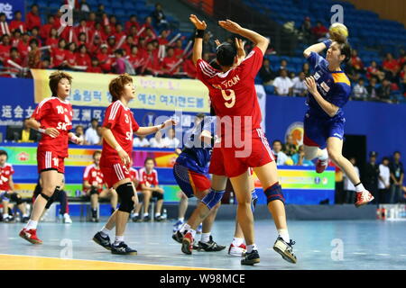 Players of Japan (Blue) and players of South Korea compete in a match during the Womens Handball Asian Qualification for 2012 Olympic Games in Changzh Stock Photo